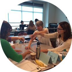 Teachers pulling string in center of table