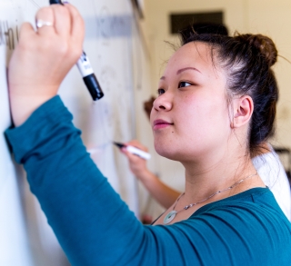 Students writing on white board