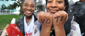 Girl with "vote" written on hands